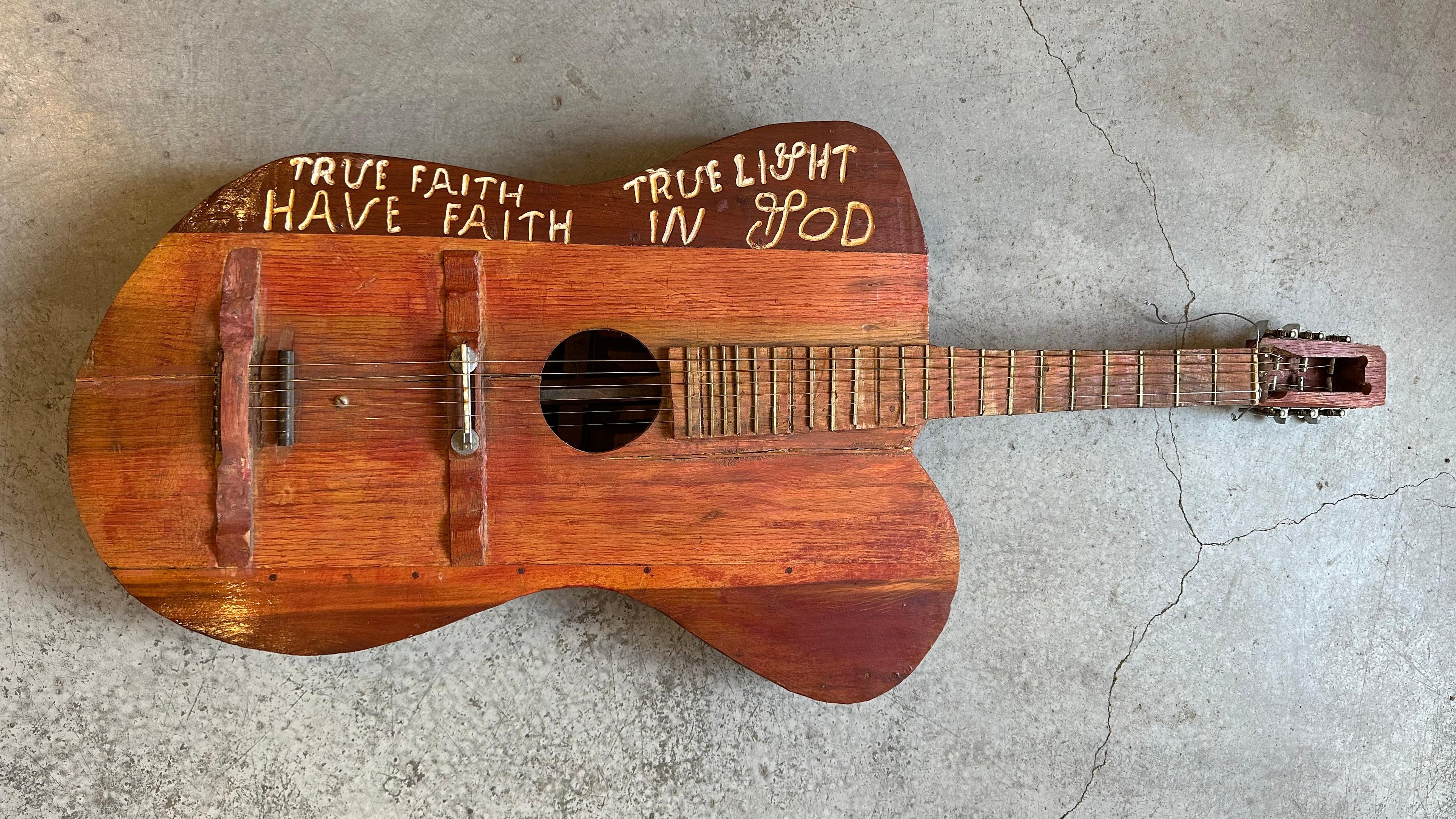 Large guitar with irregular proportions and a transcription True Faith True Light Have Faith in God